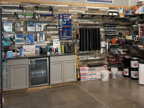 Caulk guns, hand tools and job-site accessories on the showroom wall